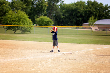 Young Baseball Player Child Standing on First Base Waiting to Run