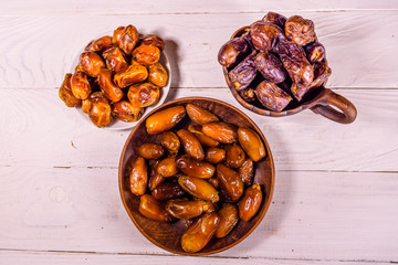 Date fruits on the white wooden table. Top view