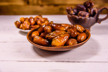 Date fruits on the white wooden table