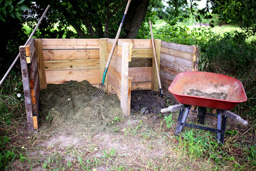 Homemade Wooden 2 Stage Compost Bin with Whell Barrow in the Garden