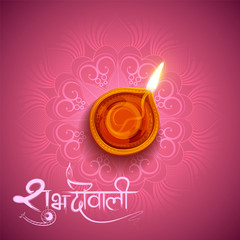Burning diya on Diwali Holiday background for light festival of India with message in Hindi meaning Happy Dipawali