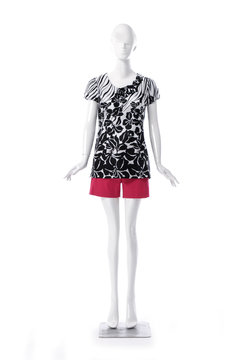 female floral clothing with red shorts on full-length mannequin isolated-white background