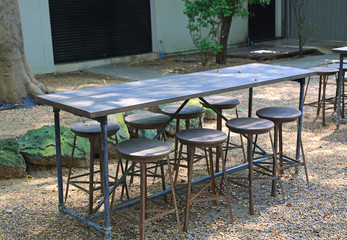 Wooden table and stool in the garden.