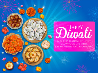 Burning diya with assorted sweet and snack on Happy Diwali Holiday background for light festival of India