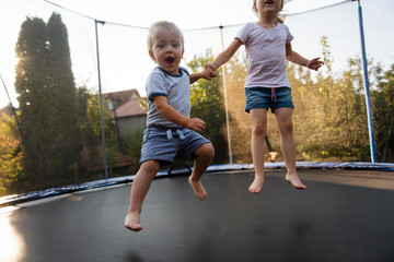 Little kids having fun in backyard