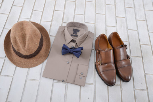 Set of mans fashion and accessories on white brick wall