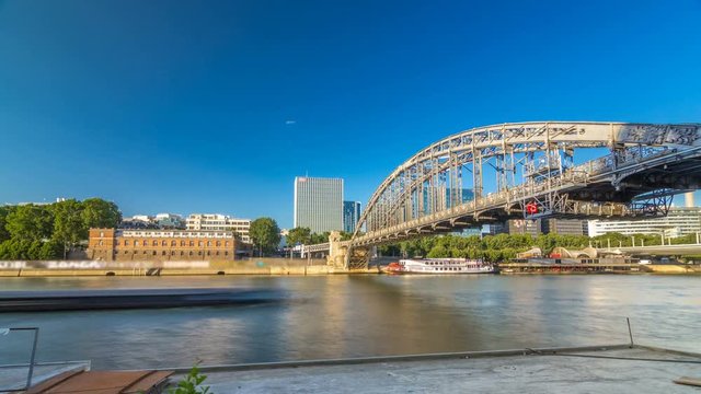 The Austerlitz viaduct in Paris timelapse hyperlapse, seen from bank of the river Seine with a metro train passing