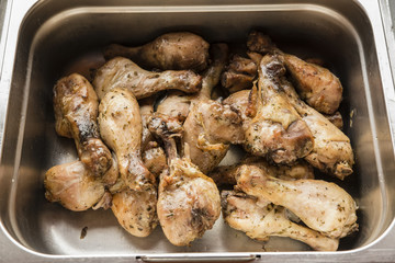 Roasted chicken legs in bacon.