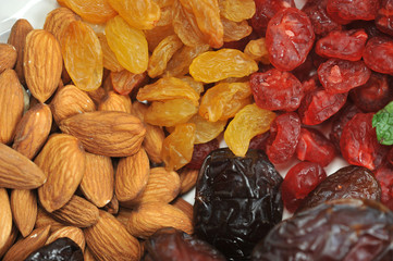 Almonds, raisins, cherries, dates occupy the entire frame space. View from above. Macro photography.