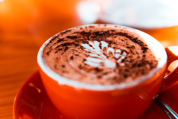 A cup of coffee on blurred background.