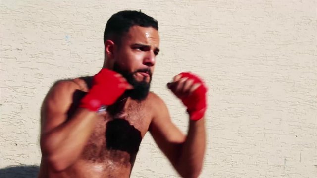 Boxer training in a wrehouse - close up - in slow motion - actor arabic / latino