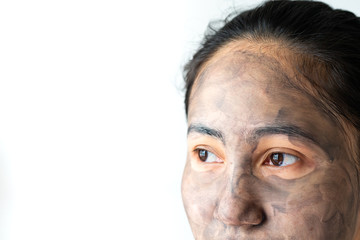 asia woman applied charcoal mask on her bare face