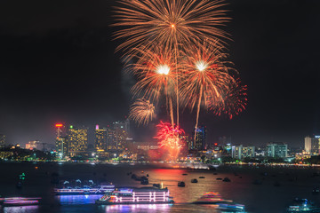 Colorful of Pattaya Firework Festival With Cityscape Night Scenery View at Pattaya Beach, Thailand....