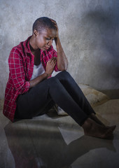 lifestyle indoors portrait of young sad and depressed black afro