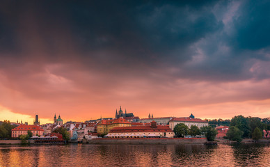 Fototapeta na wymiar Stunning cityscape of Prague on a sunset in Czech Republic. Vltava river, Prazsky hrad (Prague castle).