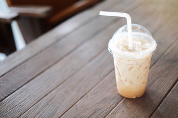 Ice coffee on the wooden table, bokeh background