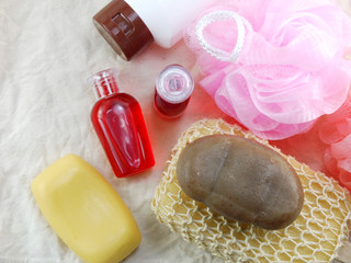 shampoo and liquid shower gel with bath puff and loofah spa kit top view