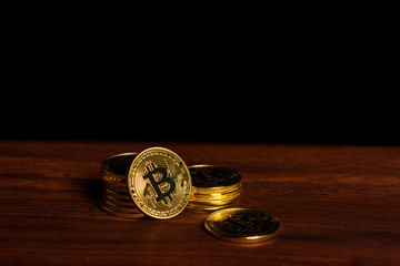 Bitcoins on wooden desk.