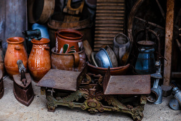 Vintage kitchen utensils on rustic wood background. Closeup with low key, natural side-lighting for effect.