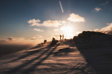 Fototapeta premium Climbers helping at on top mountain