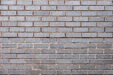 Weathered grey stained brick wall