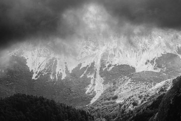 Obraz premium Mountain cliff during storm. Black and white image.