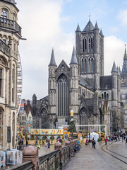 GHENT, BELGIUM - December, 2017: View of the ancient bridge of Saint Michael, old post office and church of St. Nicholas in the historical center of Ghent, Belgium