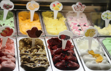 many flavors of ice cream on sale in the window of the Italian i