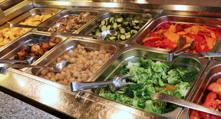 self-service restaurant with many trays filled with broccoli pep