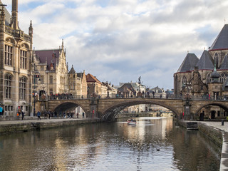 Gent - Medieval cathedral and bridge over a canal in Ghent, Belgium. December, 2017