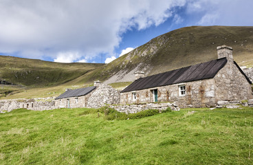 Obraz premium A view of Main Street, Village Bay, St. Kilda, showing both the ancient and newer blackhouses