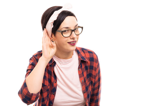Young pretty pin-up girl wearing glasses showing can't hear gesture.