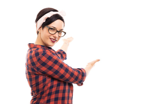 Young pretty pin-up girl wearing glasses showing copyspace.