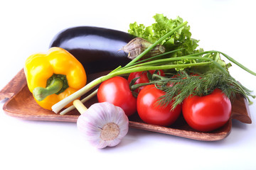 Fresh assorted vegetables, eggplant, bell pepper, tomato, garlic with leaf lettuce. Isolated on white background. Selective focus.