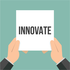 Man showing paper INNOVATE text