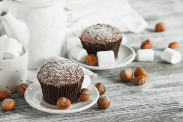 Chocolate cupcakes, marshmallow and different Christmas decorations