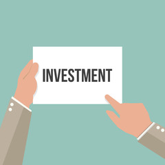 Man showing paper INVESTMENT text