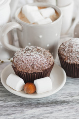 Chocolate cupcakes, marshmallow and different Christmas decorations