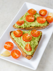 AVOCADO TOAST WITH CHERRY TOMATOES