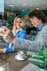 Coworkers taking a selfie during coffee break