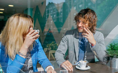 Coworkers flirting on coffee break in cafeteria