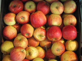 Red apples in a drawer close-up