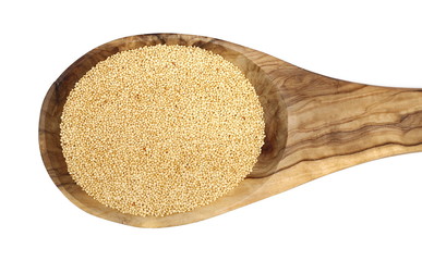 Amaranth seeds in wooden spoon isolated on white background, top view