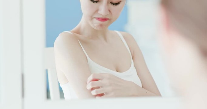woman scratching her arm