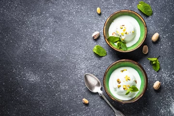 Stoff pro Meter Pistachios ice cream in bowls on black stone table. © nadianb