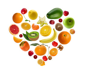 A lot of fruits and berries lie in the shape of heart isolated on white background. Vitamin kit.