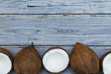 Coconuts on a rustic wooden background.