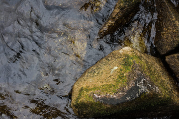 big stone at water shore