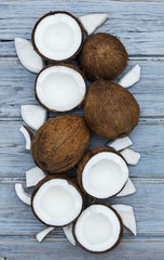 Coconuts on a rustic wooden background.