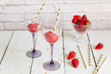 Two wineglasses with strawberry sorbet